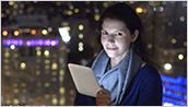 NOOK GlowLight - Laura with NOOK GlowLight in front of skyline